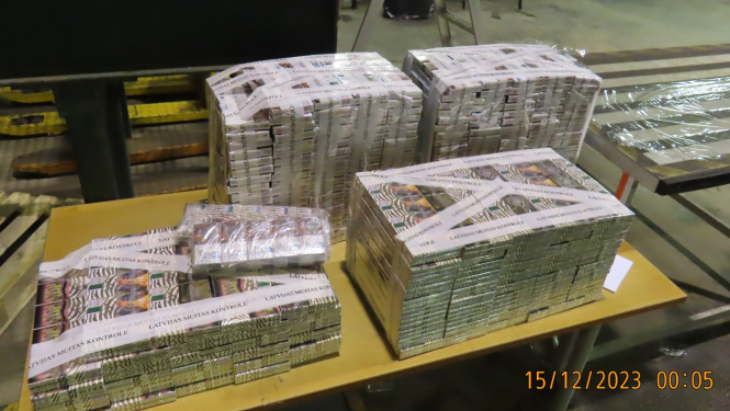Lieli iepakojumi ar muitas amatpersonu izņemtām kontrabandas cigaretēm “NZ Gold” stāv uz galda